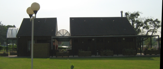 wooden buildings, the smart toilet block and reception at Le Nouvion-en-Thiérache  campsite